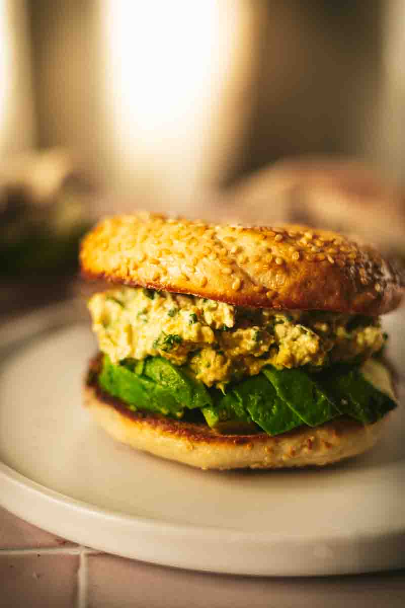 Breakfast Bagel with vegan Egg Salad made of chickpeas and tofu and Avocado